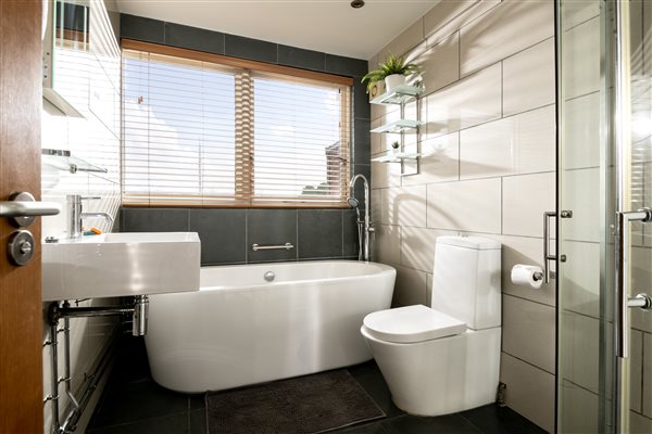 Family bathroom with bath and walk-in shower.